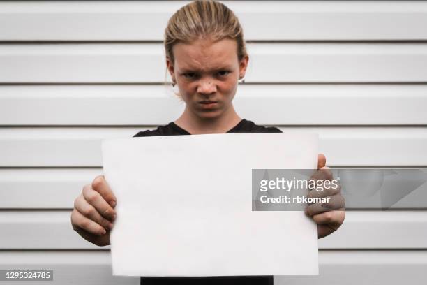 angry teen girl protests holding white cardboard in her hands. free space for text, inscriptions - 15 years girl bare stock pictures, royalty-free photos & images