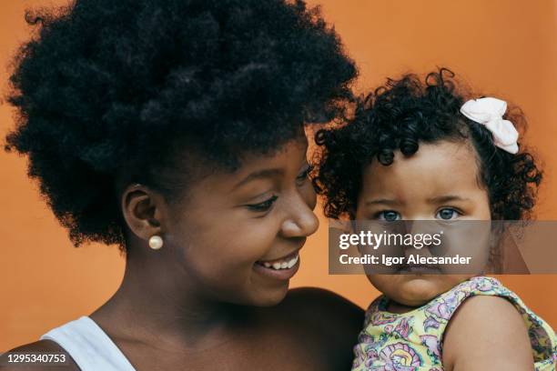 portrait of mother and baby daughter - anti racism children stock pictures, royalty-free photos & images