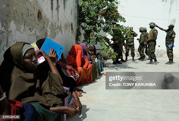 Residents of Mogadishu wait at an Africa Union peacekeeping mission in Somalia clinic on October 5, 2011 in Mogadishu where some four million Somalis...