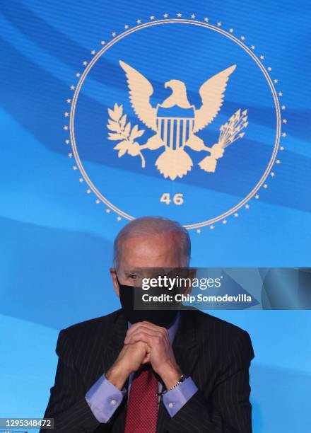 President-elect Joe Biden looks on after announcing members of his cabinet that will round out his economic team, including secretaries of commerce...