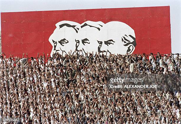 Supporters of pro-communist Ethiopian Workers' party wave in front of a huge portraits of the founders of the "scientific socialism" Karl Marx,...