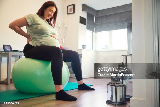 smiling pregnant lady on gym ball - new sport content stock pictures, royalty-free photos & images