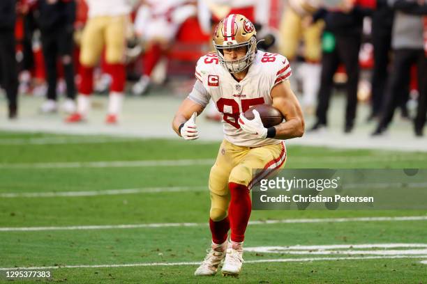 Tight end George Kittle of the San Francisco 49ers runs with the football after a reception against the Seattle Seahawks during the first half of the...