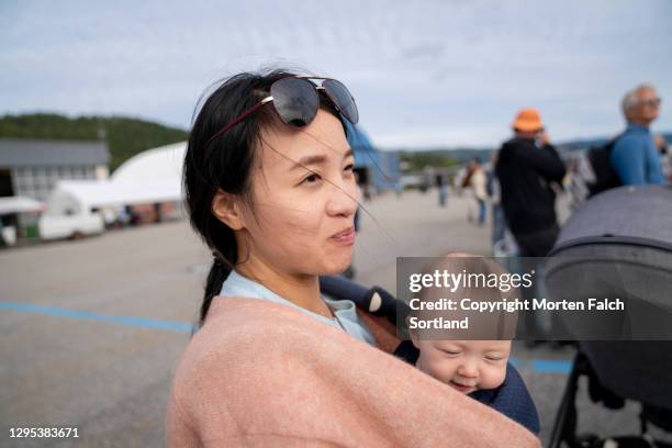 mommy and baby attending an event in notodden, norway - airport tarmac stock pictures, royalty-free photos & images