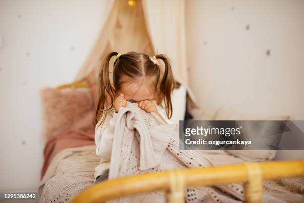 gråtande liten flicka i sängen - rädda bildbanksfoton och bilder