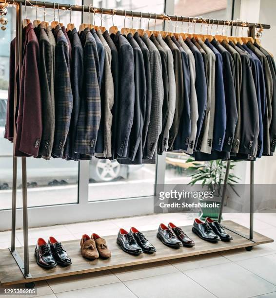 suits on rack - men fashion suit stock pictures, royalty-free photos & images