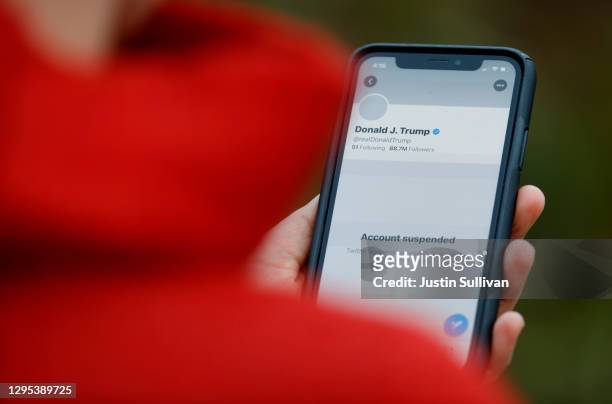 The suspended Twitter account of U.S. President Donald Trump appears on an iPhone screen on January 08, 2021 in San Anselmo, California. Citing the...