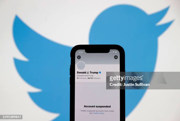 The suspended Twitter account of U.S. President Donald Trump appears on an iPhone screen on January 08, 2021 in San Anselmo, California. Citing the...