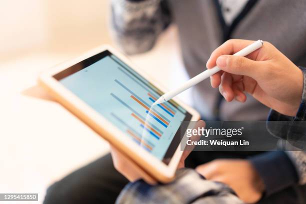 man using tablet to see chart - business strategy stock pictures, royalty-free photos & images