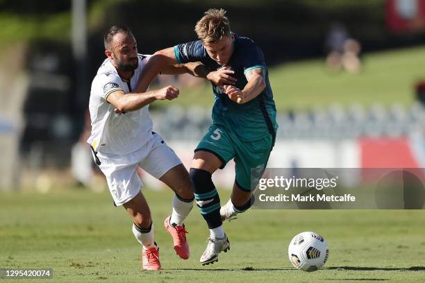 James McGarry of the Phoenix and Ivan Franjic of the Bulls compete for the ball during the A-League match between Macarthur FC Bulls and the...