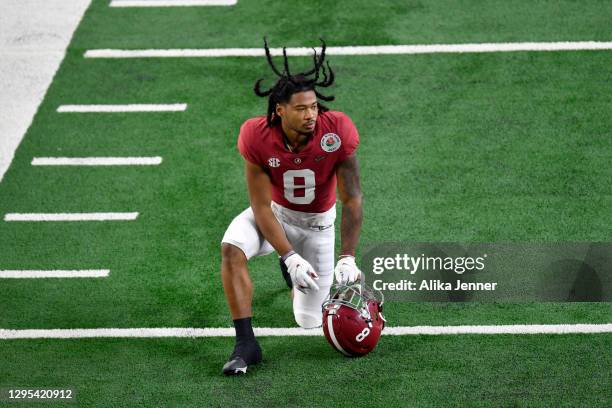 John Metchie III of the Alabama Crimson Tide kneels before the College Football Playoff Semifinal at the Rose Bowl football game against the Notre...