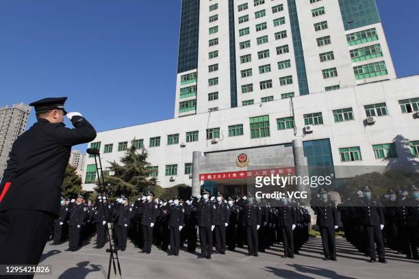 Police officers attend a flag-raising ceremony at a police station to mark the Chinese people's police day, starting on January 10 this year, on...