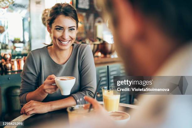 lovely couple having date in a cafe. - couple in cafe coffee stock pictures, royalty-free photos & images