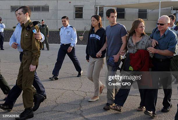 In this handout photo provided by the the Israeli Government Press Office , freed Israeli soldier Gilad Shalit is followed by his family after...