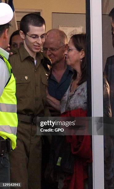 In this handout photo provided by the the Israeli Government Press Office , freed Israeli soldier Gilad Shalit meets with his mother Aviva and his...