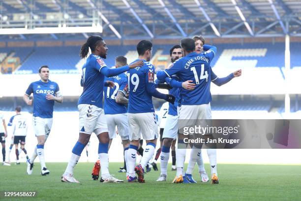Cenk Tosun of Everton celebrates with Alex Iwobi , Anthony Gordon and teammates after scoring their team's first goal during the FA Cup Third Round...