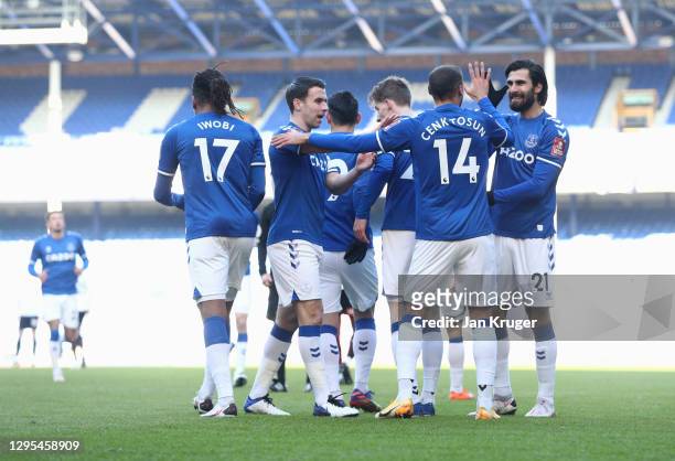 Cenk Tosun of Everton celebrates with teammates Seamus Coleman, and Andre Gomes after scoring his team's first goal during the FA Cup Third Round...