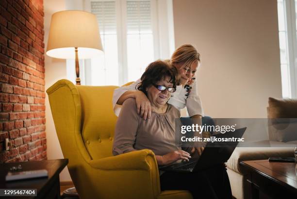 woman spending time with her elderly mother - family time stock pictures, royalty-free photos & images