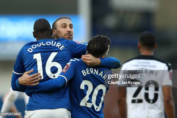 Abdoulaye Doucoure of Everton celebrates with teammates Cenk Tosun and Bernard after scoring his team's second goal during the FA Cup Third Round...