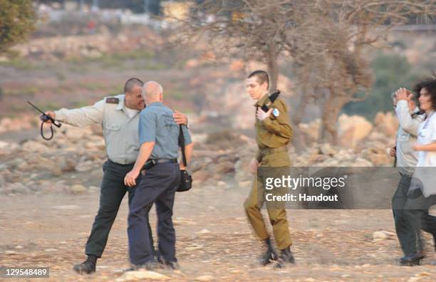 In this handout photo provided by the Israeli Police, freed Israeli soldier Gilad Shalit and his father Noam arrive at their home town on October 18,...