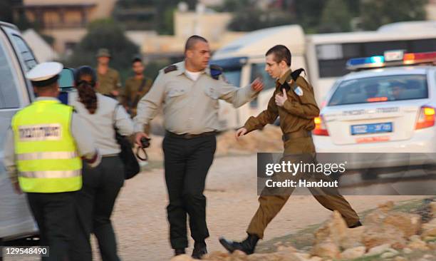 In this handout photo provided by the Israeli Police, freed Israeli soldier Gilad Shalit and his father Noam arrive at their home town on October 18,...