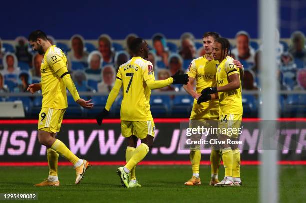 Bobby De Cordova-Reid of Fulham celebrates with teammates Joe Bryan and Neeskens Kebano after scoring his team's first goal during the FA Cup Third...