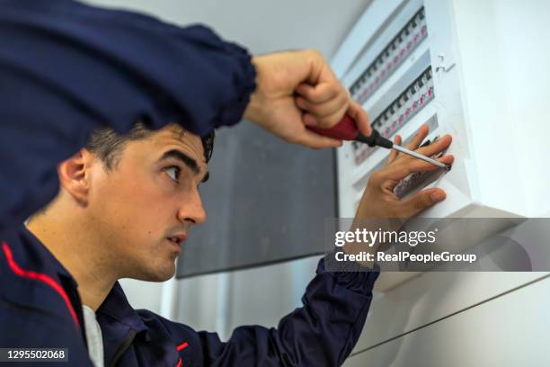 electric residential fuses box check by caucasian electrician. - fuse stock pictures, royalty-free photos & images