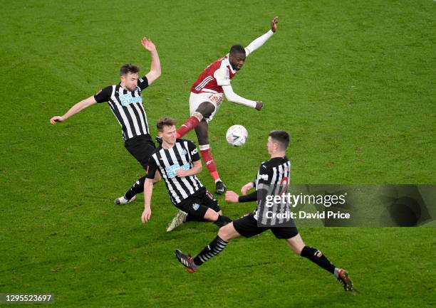 Nicolas Pepe of Arsenal shoots under pressure from Paul Dummett, Matt Ritchie and Ciaran Clark of Newcastle during the FA Cup Third Round match...