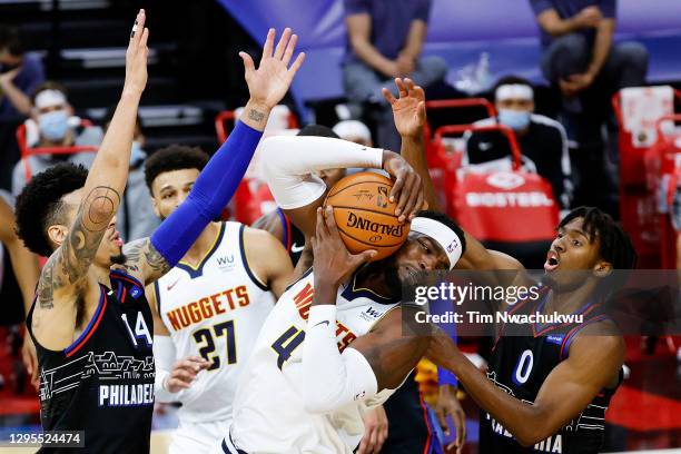 Paul Millsap of the Denver Nuggets is guarded by Danny Green and Tyrese Maxey of the Philadelphia 76ers during the first quarter at Wells Fargo...