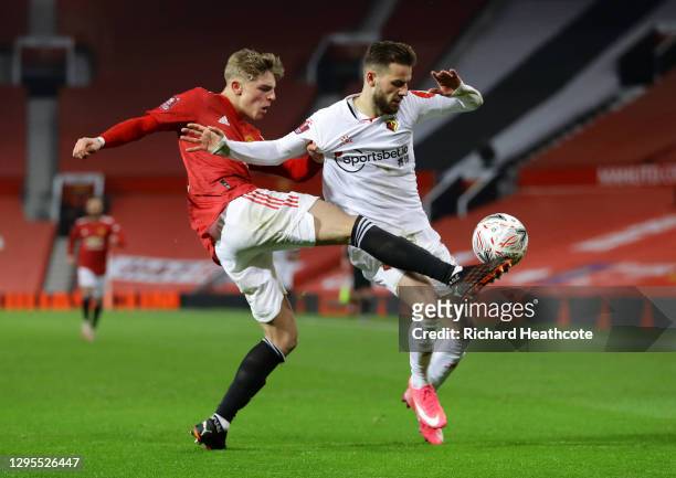 Brandon Williams of Manchester United tackles Philip Zinckernagel of Watford during the FA Cup Third Round match between Manchester United and...