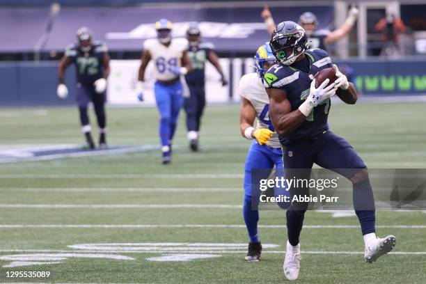 Wide receiver DK Metcalf of the Seattle Seahawks completes a reception over inside linebacker Kenny Young of the Los Angeles Rams and carries for a...