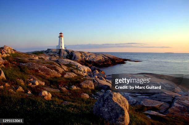 beautiful sunset along the atlantic ocean at peggy's cove, nova scotia, canada - peggy's cove stock pictures, royalty-free photos & images