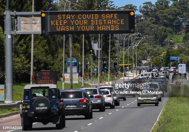 Traffic heading towards the city are warned about Covid-19 on digital displays at North Narrabeen on January 10, 2021 in Sydney, Australia. From...