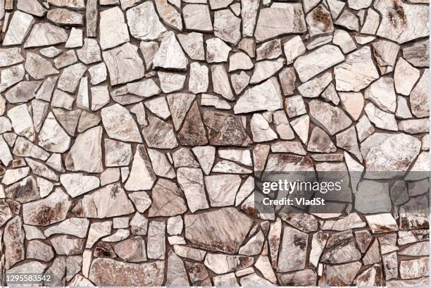 mosaic crushed river rock stone wall masonry vector background - marble surface stock illustrations