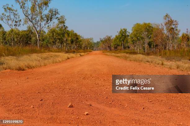 the red centre roads in the australian outback. unsealed roads. - uluru road stock-fotos und bilder