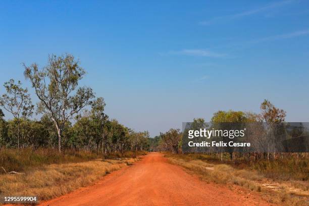 the red centre roads in the australian outback. unsealed roads. - darwin australia stock pictures, royalty-free photos & images