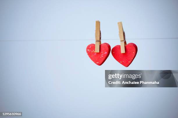 love emotion concepts: couple red heart shape with blurred background - february background stock-fotos und bilder