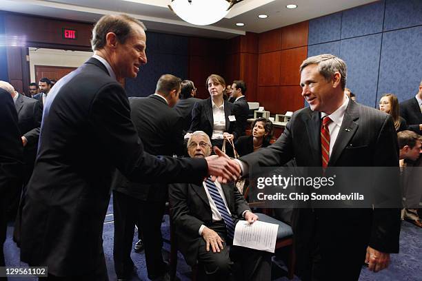 Sen. Ron Wyden shakes hands with U.S. Sen. Mark Kirk before a news conference about the 25th anniversary of the Electronic Communications Privacy Act...