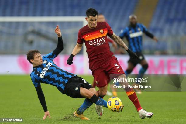 Roger Ibanez of Roma tackled by Nicolo Barella of Internazionale during the Serie A match between AS Roma and FC Internazionale at Stadio Olimpico on...