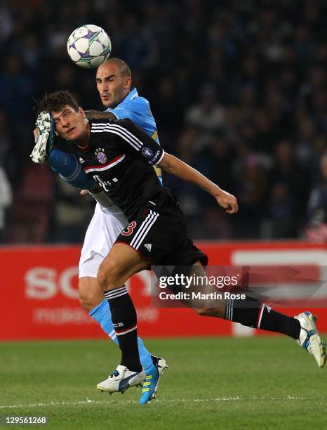 Paolo Cannavaro of Naples and Mario Gomez of Muenchen battle for the ball during the UEFA Champions League group A match between SSC Napoli and FC...