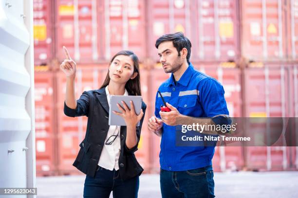 shipper and customs officer discuss together over digital tablet at cargo container.  freight forwarde business. - government intelligence stock pictures, royalty-free photos & images