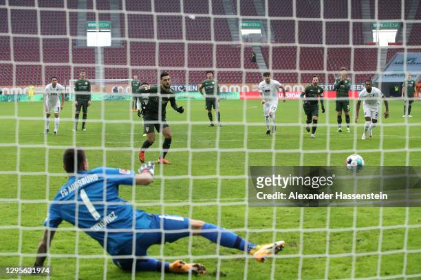 Nicolas Gonzalez of VfB Stuttgart scores their side's first goal from the penalty spot past Rafal Gikiewicz of FC Augsburg during the Bundesliga...