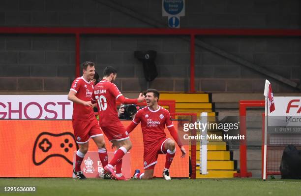 Jordan Tunnicliffe of Crawley Town celebrates with teammates Tony Craig and Ashley Nadesan after scoring their team's third goal during the FA Cup...