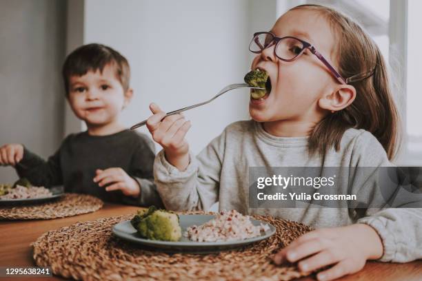 siblings eat healthy vegan lunch at home. - vegetarian food stock pictures, royalty-free photos & images