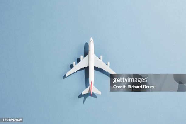 a toy aeroplane against a blue background - model airplane ストックフォトと画像
