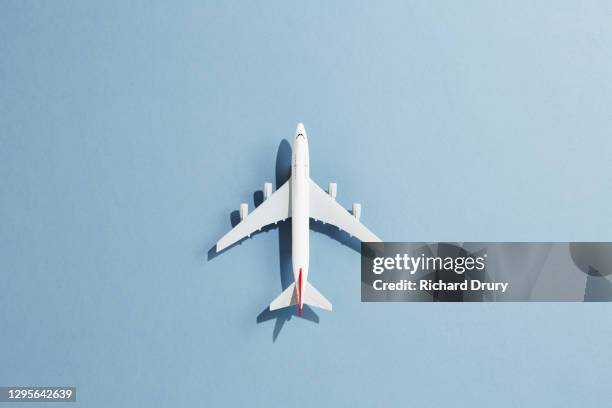 a toy aeroplane against a blue background - model aeroplane stock pictures, royalty-free photos & images