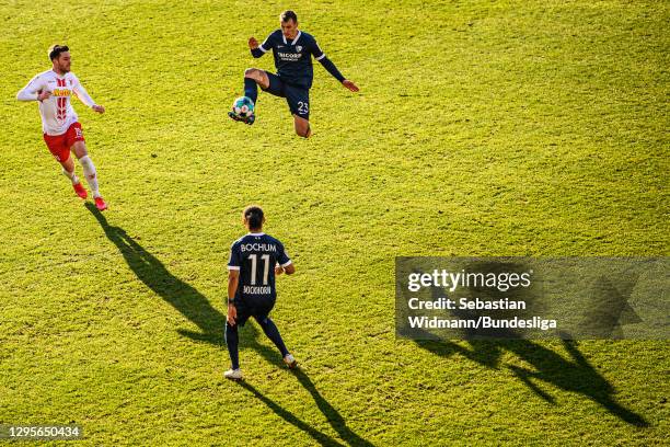 Robert Tesche of VfL Bochum plays the ball in front of Andreas Albers of Regensburg and team mate Herbert Bockhorn during the Second Bundesliga match...