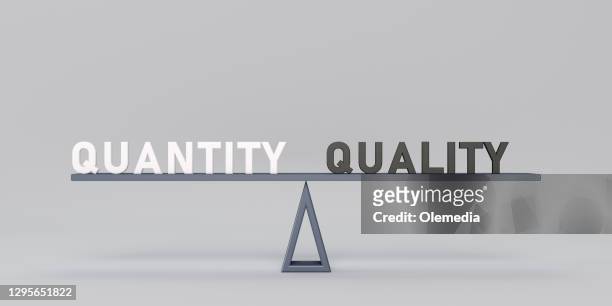 quantity and quality text on seesaw - abundance stock pictures, royalty-free photos & images