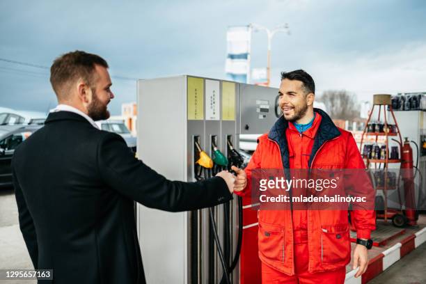 people on gas station - gas station attendant stock pictures, royalty-free photos & images