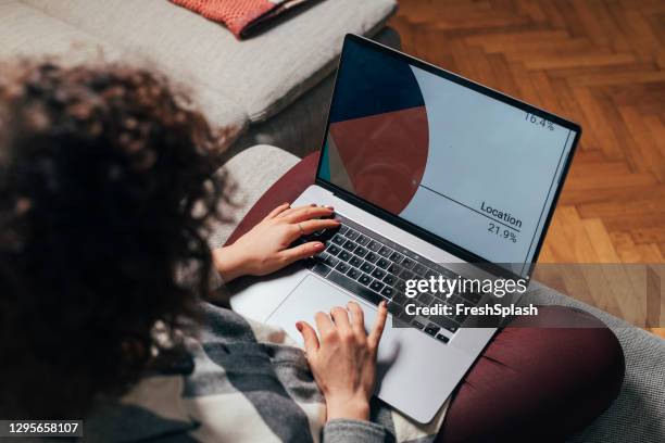 hands of an anonymous woman using her laptop to work from home, a close up - using laptop screen stock pictures, royalty-free photos & images